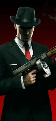 Hitman на фоне взрывов с пистолетами - обои на телефон