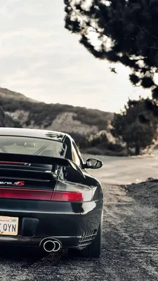 Grey and black Porsche 911 GT3 rs in front of a white and black villa with  a pool | Wallpapers.ai